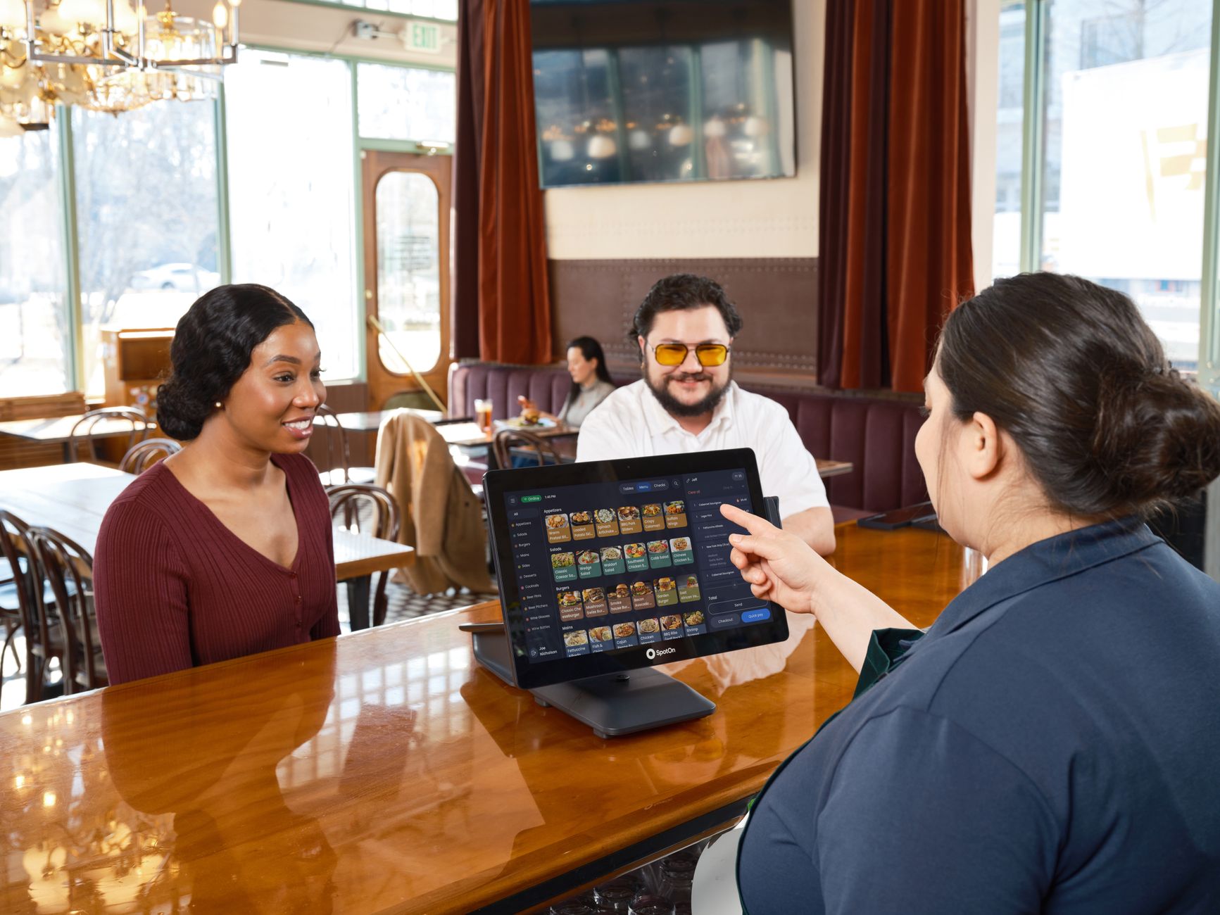Pregnant diner asking server a friendly question about menu safety
