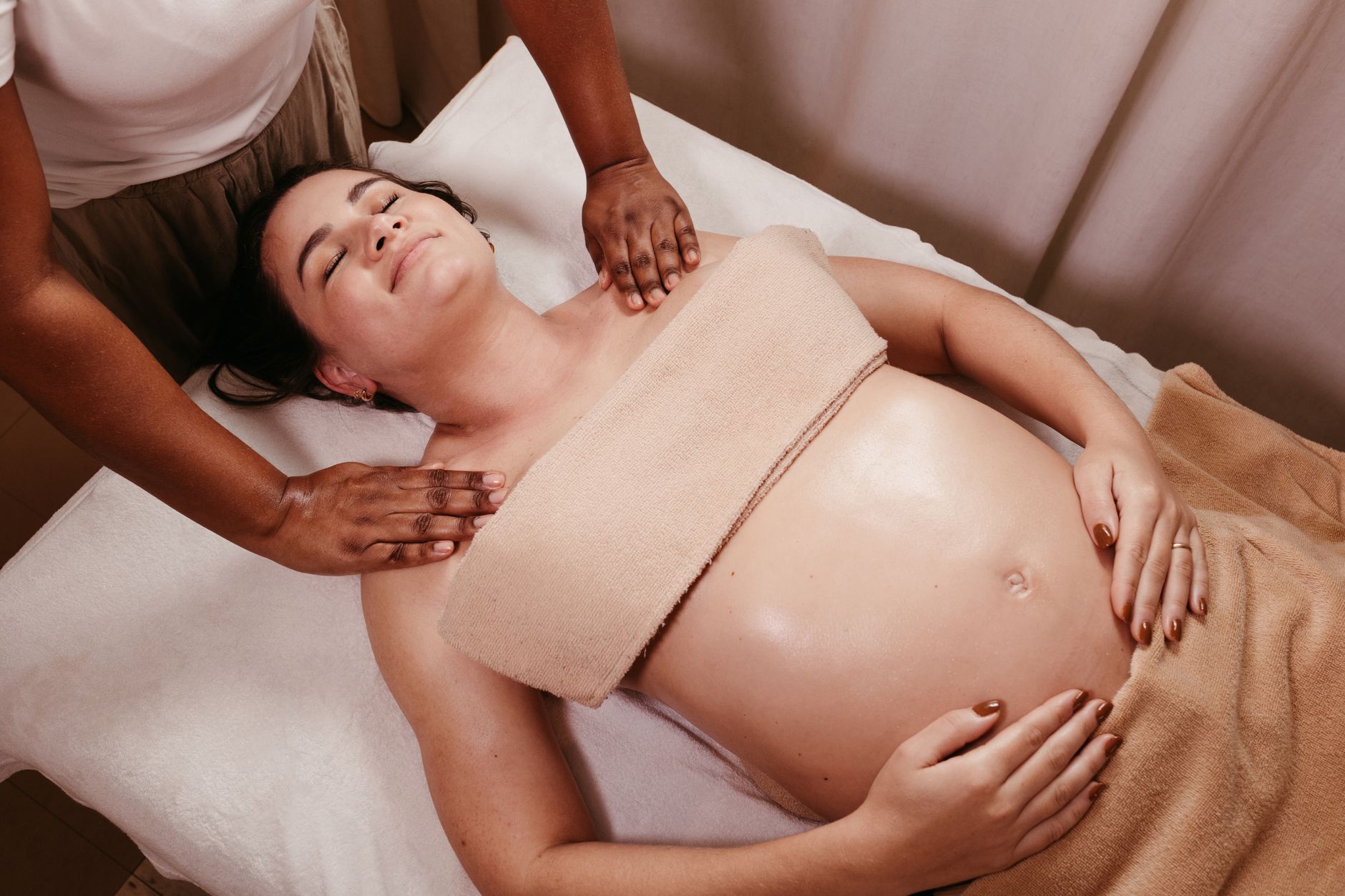 Pregnant woman in gentle prenatal yoga pose by window light